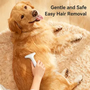 White ergonomic pet grooming brush removing floating hair from a golden retriever
