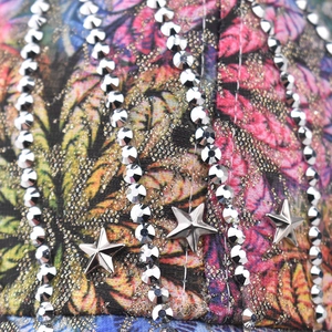Macro detail of star baseball cap featuring silver rhinestones and colorful patterns