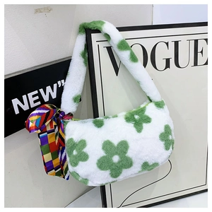Detail of plush white faux fur shoulder bag with green floral patterns and silk scarf decor
