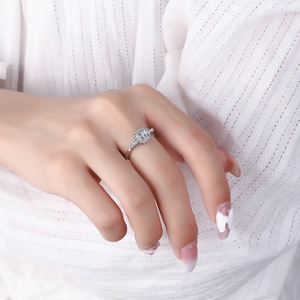Women's silver wide band ring with round cubic zirconia diamonds on finger