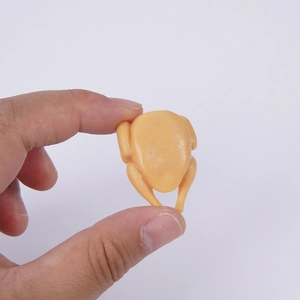 Realistic 3cm mini roast chicken food keychain pendant shown being held by fingertips