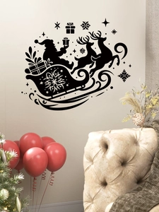 Detail of black Santa sleigh PVC wall sticker on a white wall in a cozy living room scene