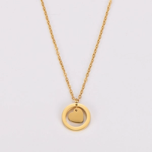 Detail of a gold stainless steel necklace featuring a circle pendant with a solid heart