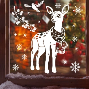 Detail of white reindeer and snowflake static window clings on glass with snowy foreground