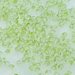 Macro detail of round light green crackle glass beads for DIY jewelry making and crafts