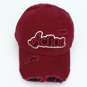 Detail of the 3D Action embroidery and distressed finish on a burgundy baseball cap