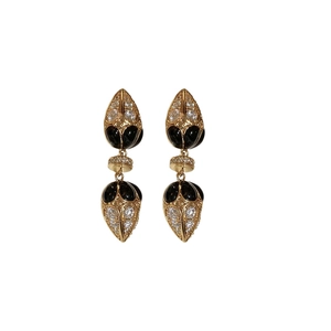 French vintage gold leaf drop earrings with black enamel and zircons on white background
