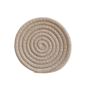 Detailed close-up of a round hand-woven cotton rope coaster with natural spiral texture