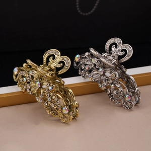 Detailed view of gold and silver hollow metal hair claws with sparkling rhinestones