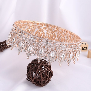 Detail of a vintage golden baroque bridal crown with sparkling heart-shaped rhinestones