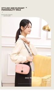 Pink shell crossbody bag featuring woven texture and black cat pendant on a model