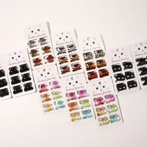 Close-up of assorted mini resin hair claws in multi-color sets on display cards
