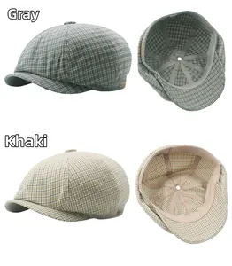 Detailed interior view of plaid newsboy caps in grey and khaki with sweatband details
