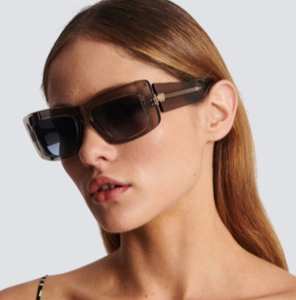 Fashionable brown cat-eye sunglasses with large rectangular resin frame on a model