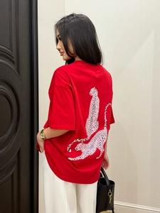 Detail of red oversized cotton T-shirt featuring pink leopard back print graphic