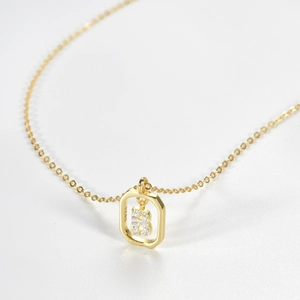 Detailed macro view of S925 sterling silver stamp on a gold-plated necklace pendant
