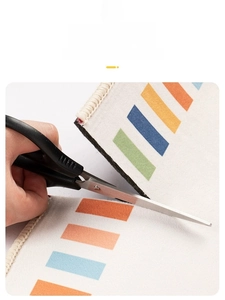 DIY colorful striped carpet mat being trimmed with scissors for custom fit and size