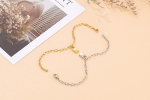 Detailed macro view of gold and silver padlock bracelets with starburst engravings