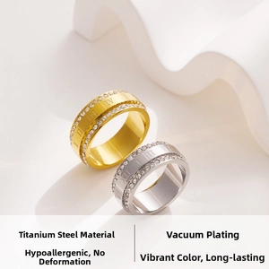 Detail of titanium steel rings with Roman numerals and double row of pavé set crystals