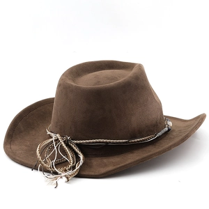 Detail of brown suede cowboy hat featuring woven decorative band and bead accents