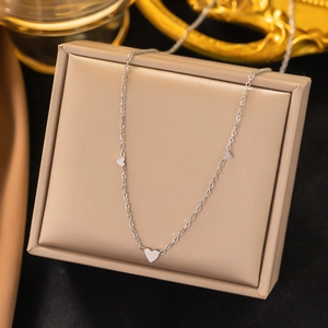Minimalist silver heart pendant necklace displayed on a luxury jewelry box