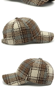 Close-up of brown plaid wool baseball cap showing metal buckle and fabric texture