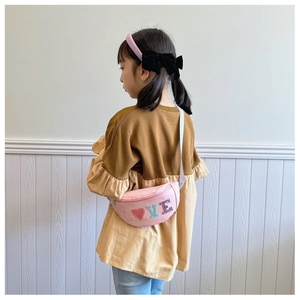 Rear view of a child wearing a pink sequin waist bag with a rainbow strap and LOVE patch