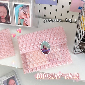 Detailed view of pink heart-shaped bubble wrap packaging for protecting small cards