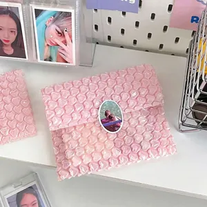 Detailed view of pink heart-shaped bubble wrap packaging for protecting small cards