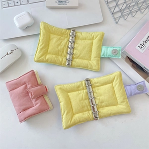 Detail of soft puffy fabric A5 binder covers with 6-hole metal rings and magnetic closure