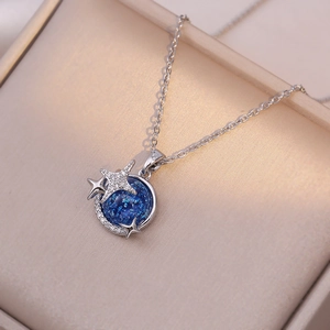 Macro detail of silver star and moon necklace with deep blue dreamlike planet zircon