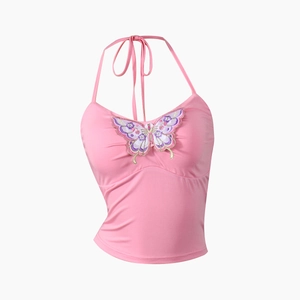 Detailopname van roze haltertop met vlinderborduursel en soepele elastische materiaalmix