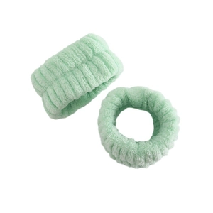 Detail view of mint green microfiber plush hairband with ribbed texture for skincare