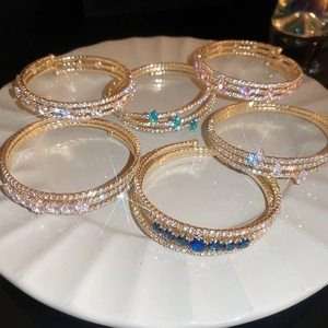 Detailed macro view of multilayer zircon inlaid bracelets with sparkling gemstones