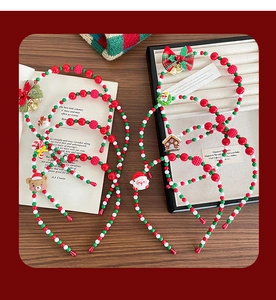 Detailed flat lay of Christmas beaded headbands with Santa, reindeer and gingerbread charms