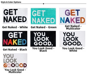 Detail view of colorful tufted bathroom mats with Get Naked and You Look Good slogans