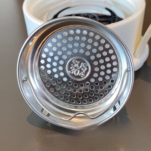 Detailed macro view of the SUS 304 stainless steel tea filter showing fine mesh holes