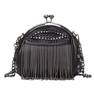 Black shell crossbody bag with silver rivet studs and fringe chain details in punk style
