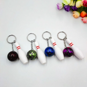 Miniature bowling ball keychain set in four marble colors with classic white pins