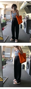 Mirror selfie showing a casual outfit with an orange canvas tote bag and floral top