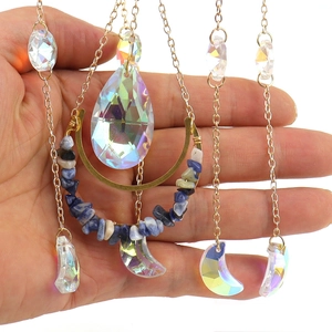 Iridescent moon crystal suncatcher with blue stones and golden hanging chains
