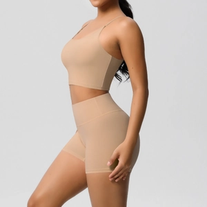 Detailed side view of high-stretch nude sports bra and biker shorts yoga set