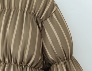 Detail of olive green and beige vertical stripes with pleated fabric and fine stitching