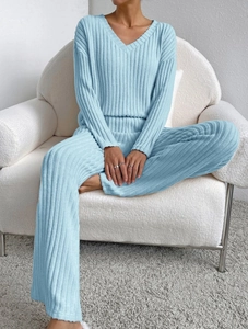 Detail of light blue V-neck knit loungewear set with vertical ribbed texture and wide legs