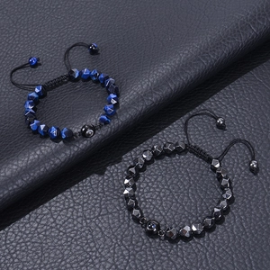 Adjustable beaded tiger eye bracelet set with obsidian stones on black leather background