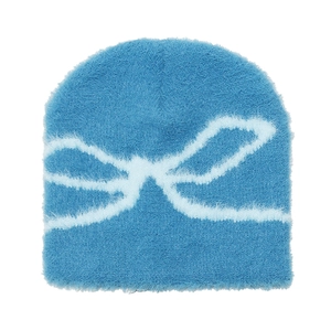Detailed view of sky blue plush beanie featuring soft jacquard bow patterns and fuzzy texture
