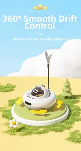 UFO shaped intelligent automatic cat toy with feather wand on soft green grass background