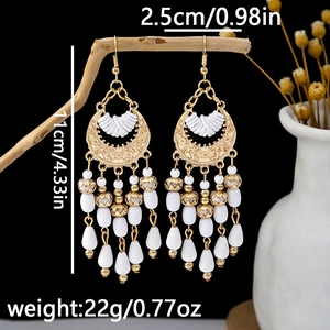 Detail showing Bohemian teardrop earrings dimensions: 11cm length and 22g weight