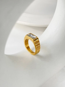 Macro detail of 18K gold plated stainless steel ring with rectangle zircon and striped band