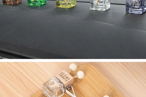 Close-up of square glass car perfume bottles with wooden diffusers and vent clips